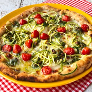 Pizza With Zucchini Spirals, Pistachio Pesto, Cherry Tomatoes, & Taleggio Cheese